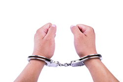 A picture of a persons wrists in handcuffs