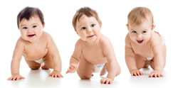 A picture of three happy babies crawling