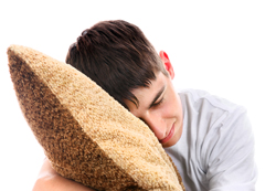A picture of a boy sleeping on a cushion