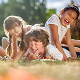 a picture of three children playing outside