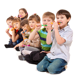 A photo of a group of children brushing their teeth