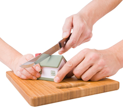 A picture of a house being cut in half on a chopping board