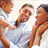 a picture of a couple holding their baby